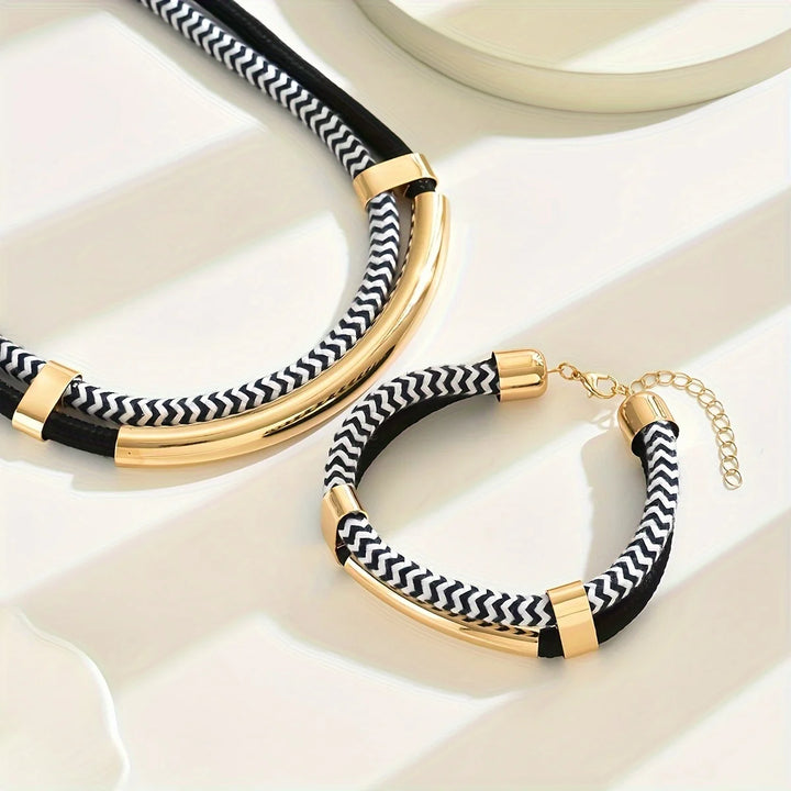 Black and white striped bracelets with gold accents on a light background