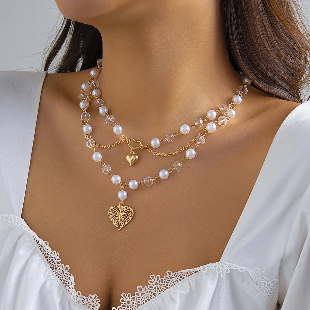Ivory pearl layered necklace with heart charm and gold-tone chain drops