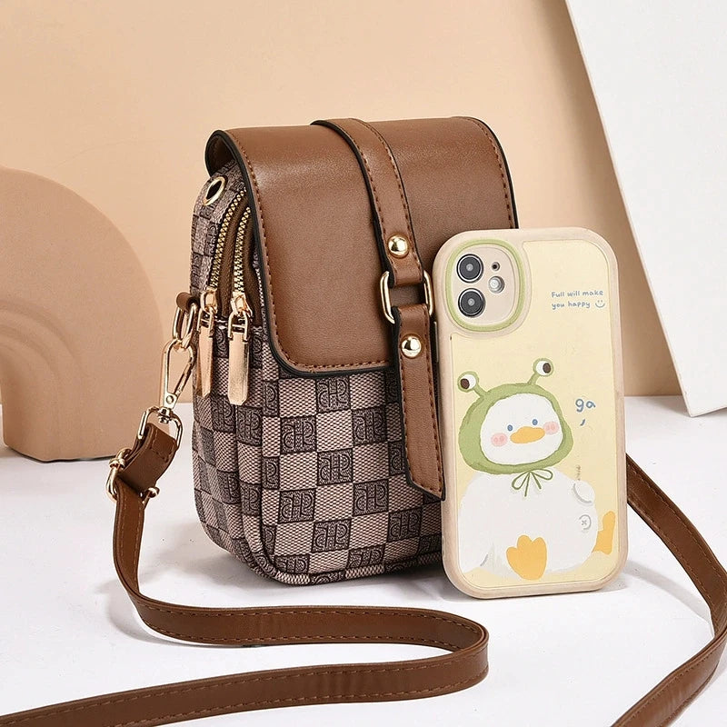 Brown checkered bag with a matching phone case featuring a cartoon design on a beige background