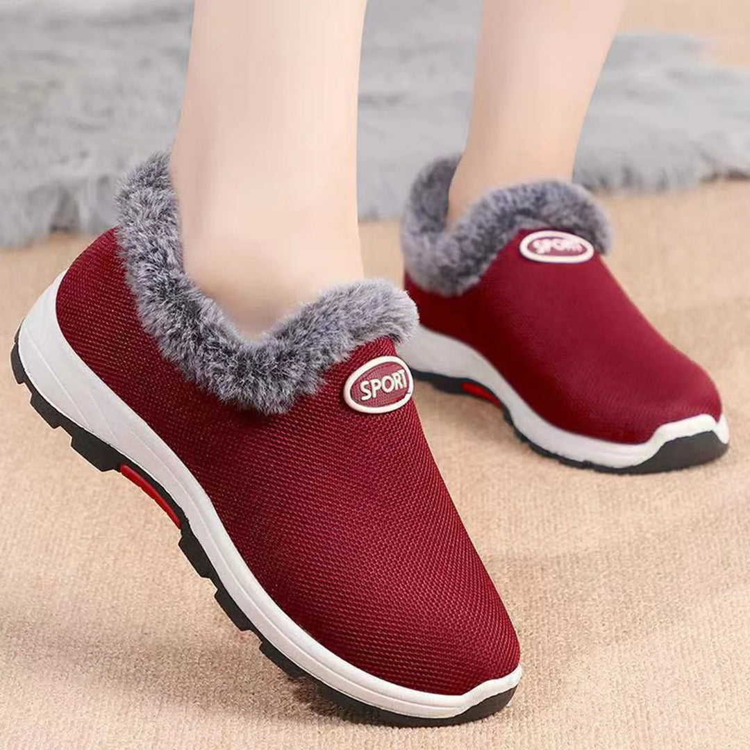 Women’s red slip-on plush sneakers with gray fuzzy collar and white rubber sole