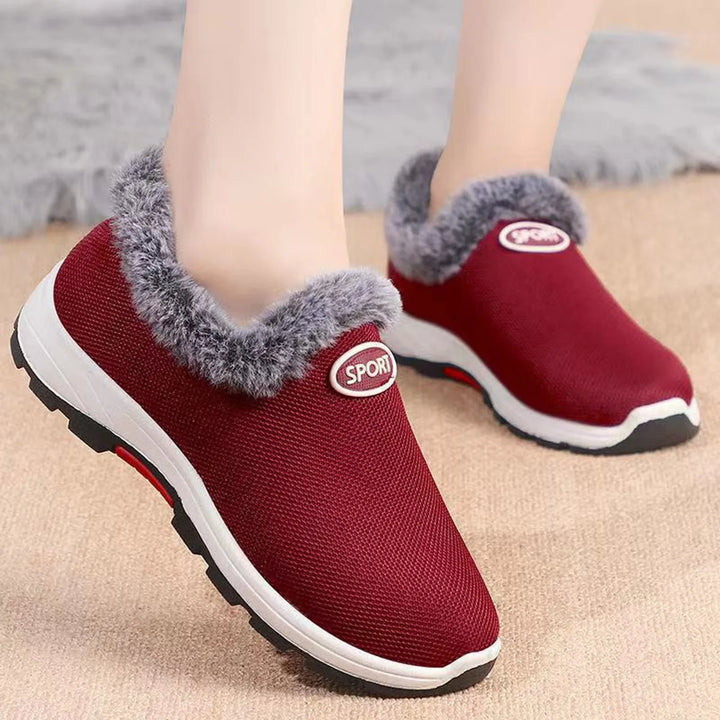 Women’s red slip-on plush sneakers with gray fuzzy collar and white rubber sole