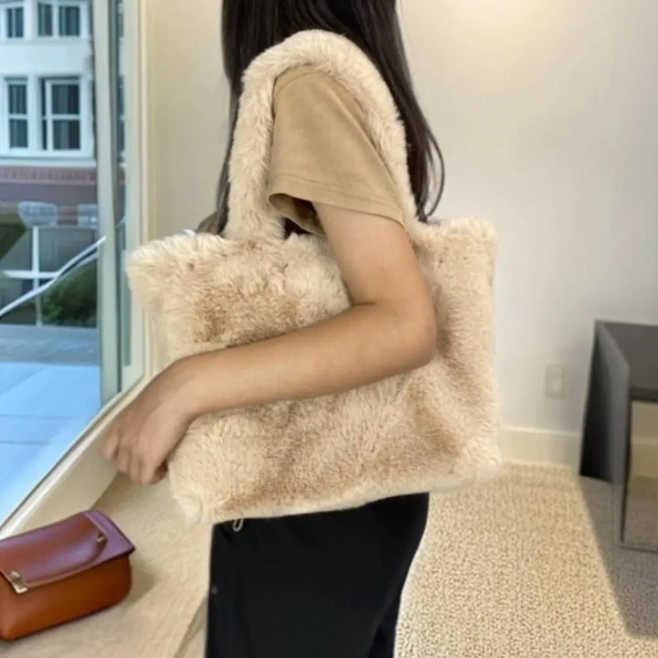 Person wearing a beige fluffy vest indoors