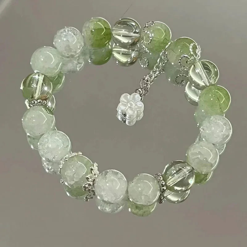 Women's green and clear crystal beaded elastic bracelet with flower charm and dangling chain