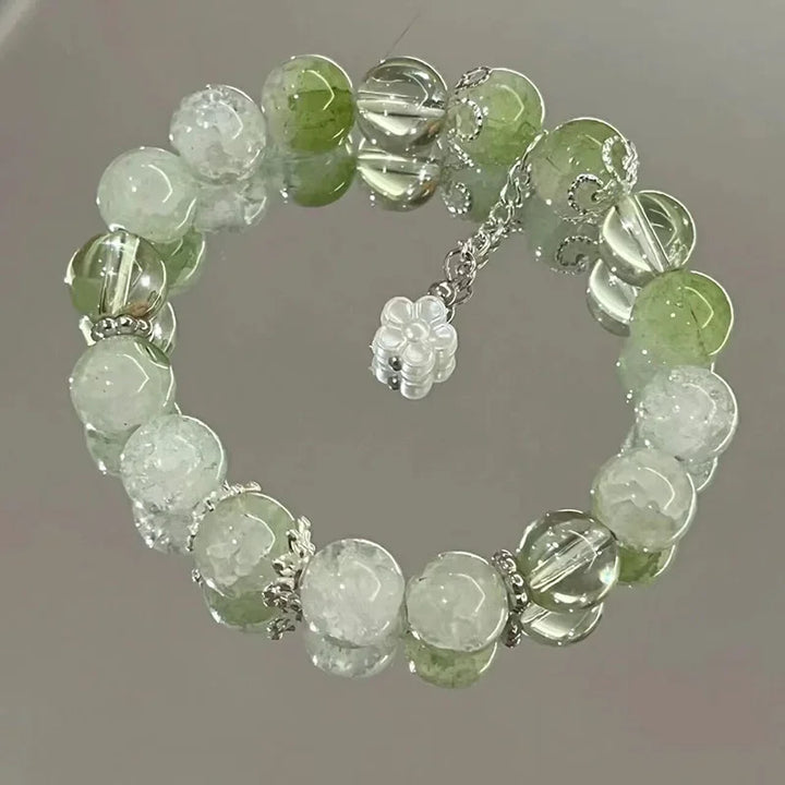 Women's green and clear crystal beaded elastic bracelet with flower charm and dangling chain