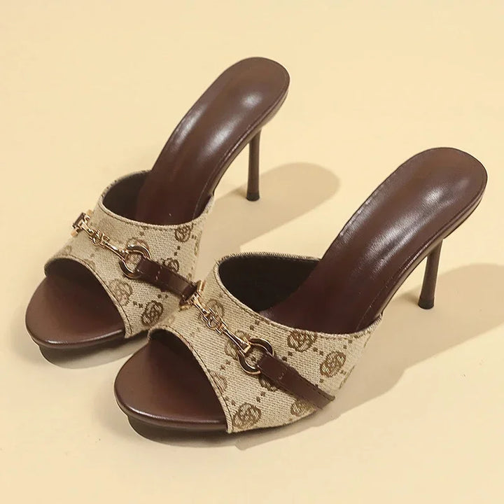 Khaki logo-print mule sandals with metal buckle straps and slim stiletto heels