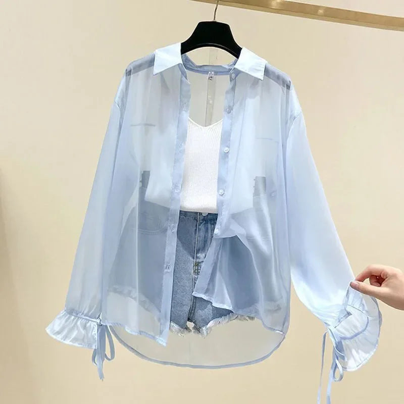 Light blue sheer button-up long sleeve shirt with ruffled cuffs and drawstring hem