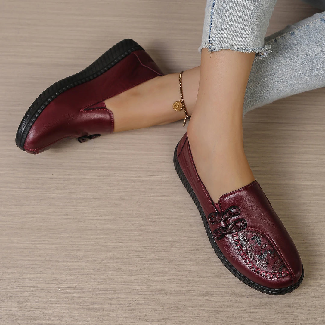 Burgundy leather slip-on loafers with butterfly-knot bow and thick textured sole edge