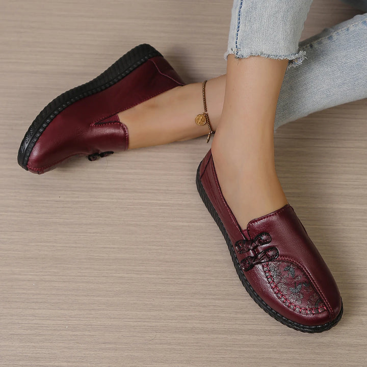 Burgundy leather slip-on loafers with butterfly-knot bow and thick textured sole edge