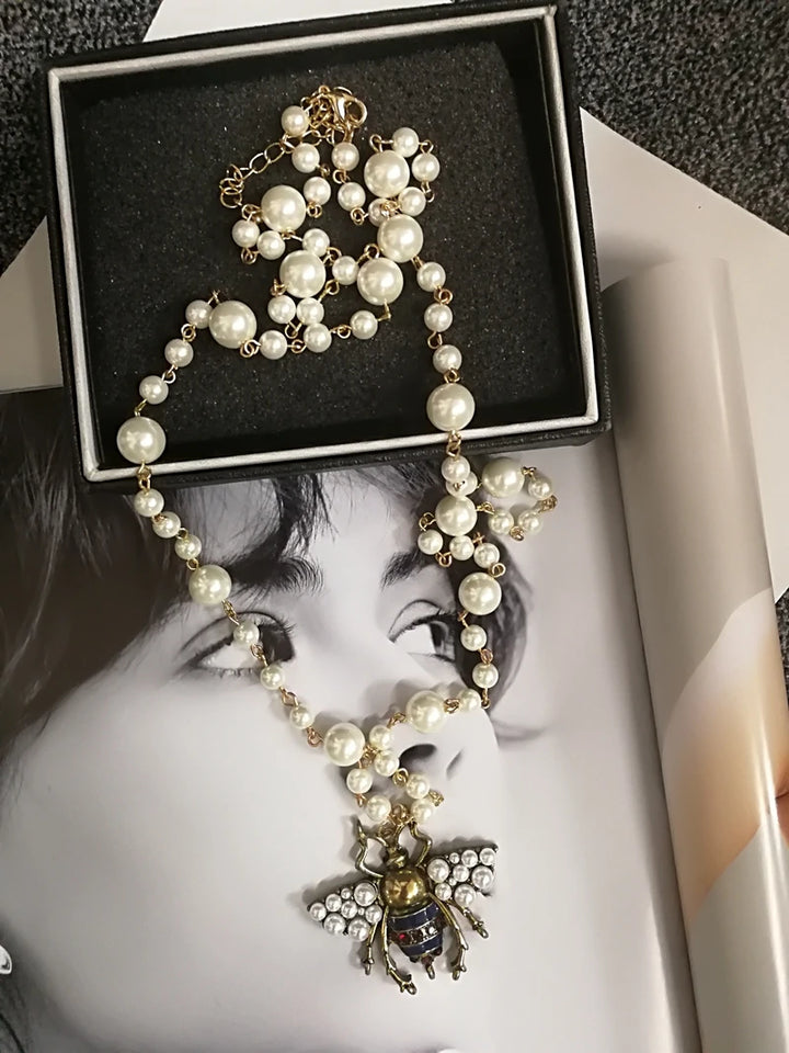Pearl necklace with a decorative pendant on a magazine cover