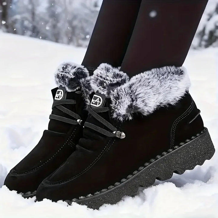 Women's black lace-up snow boots with faux-fur cuffs and grippy lug sole
