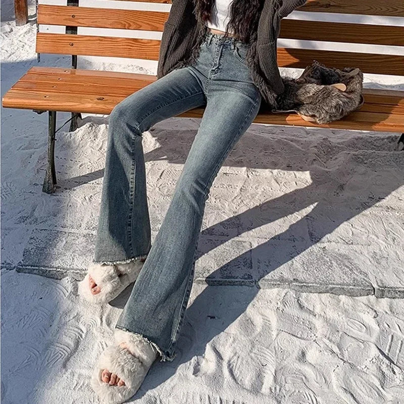 High-rise flare denim jeans, light blue wash, subtle whiskering at hips