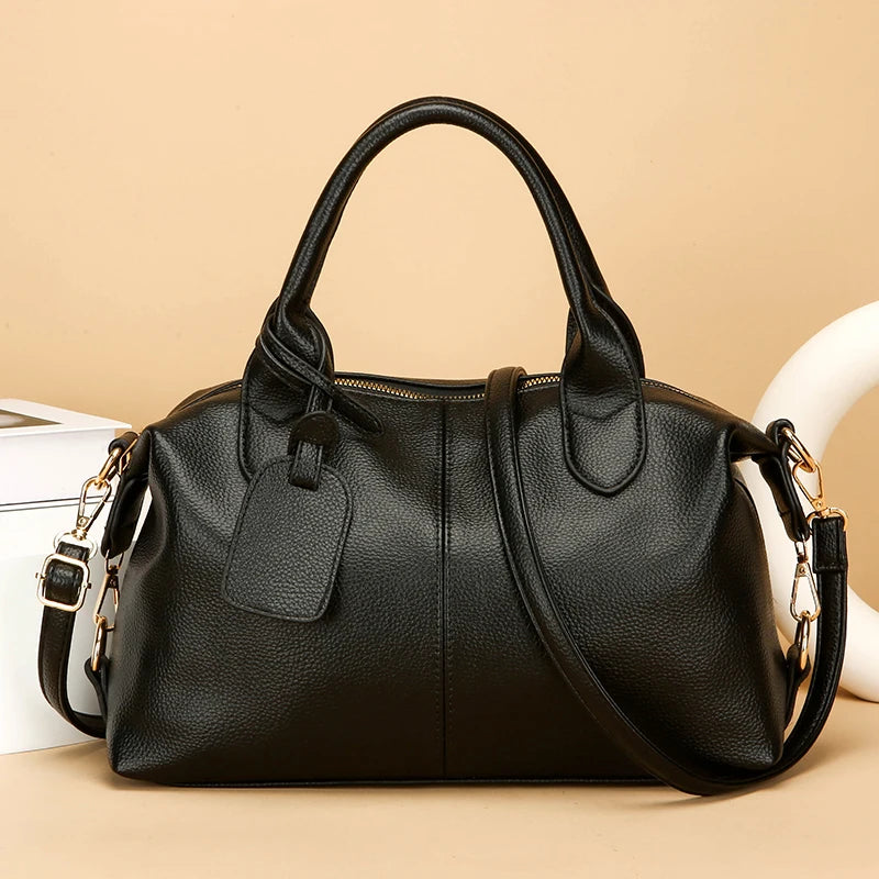 Women's soft leather tote bag in black with top handles and shoulder strap