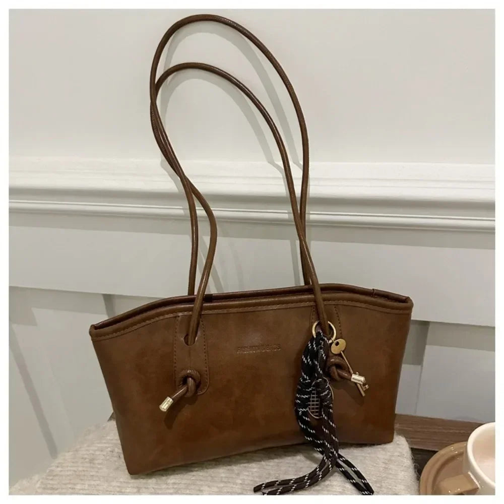 Brown PU leather tote handbag with long handles and braided crossbody strap