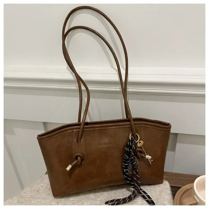 Brown PU leather tote handbag with long handles and braided crossbody strap
