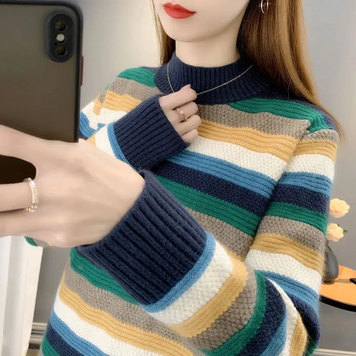 Close-up of a person wearing a multicolored striped sweater with a blurred background