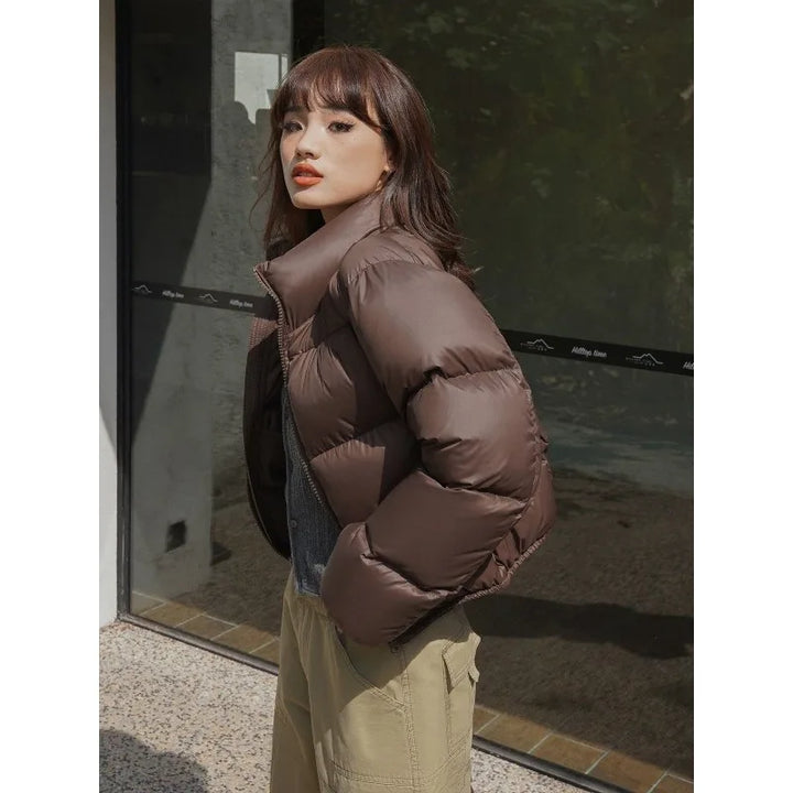 Women wearing brown thick padded puffer coat.