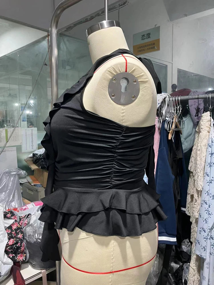 Black ruffled blouse on a mannequin in a clothing store setting