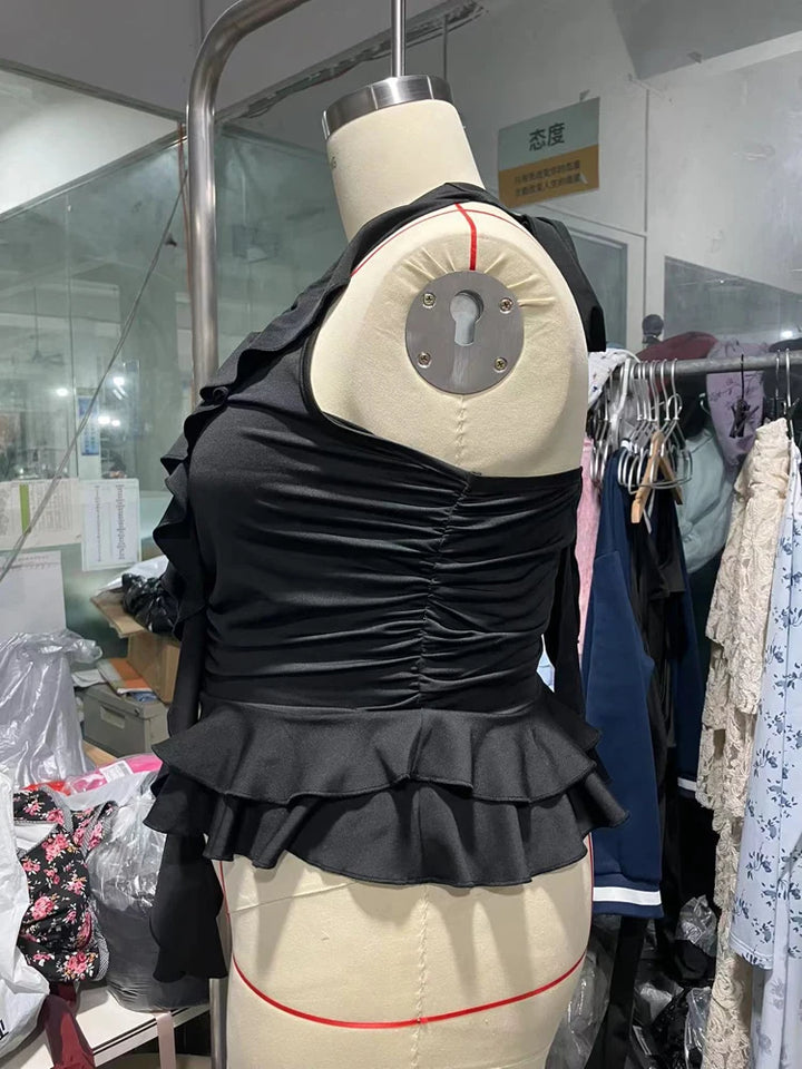 Black ruffled blouse on a mannequin in a clothing store setting