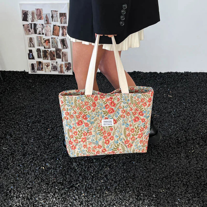 Canvas tote bag with red and blue floral print and light top handles