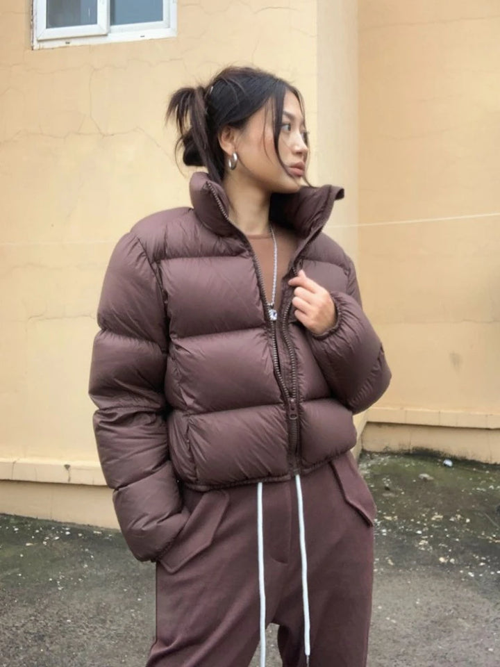 Women wearing brown thick padded puffer coat.