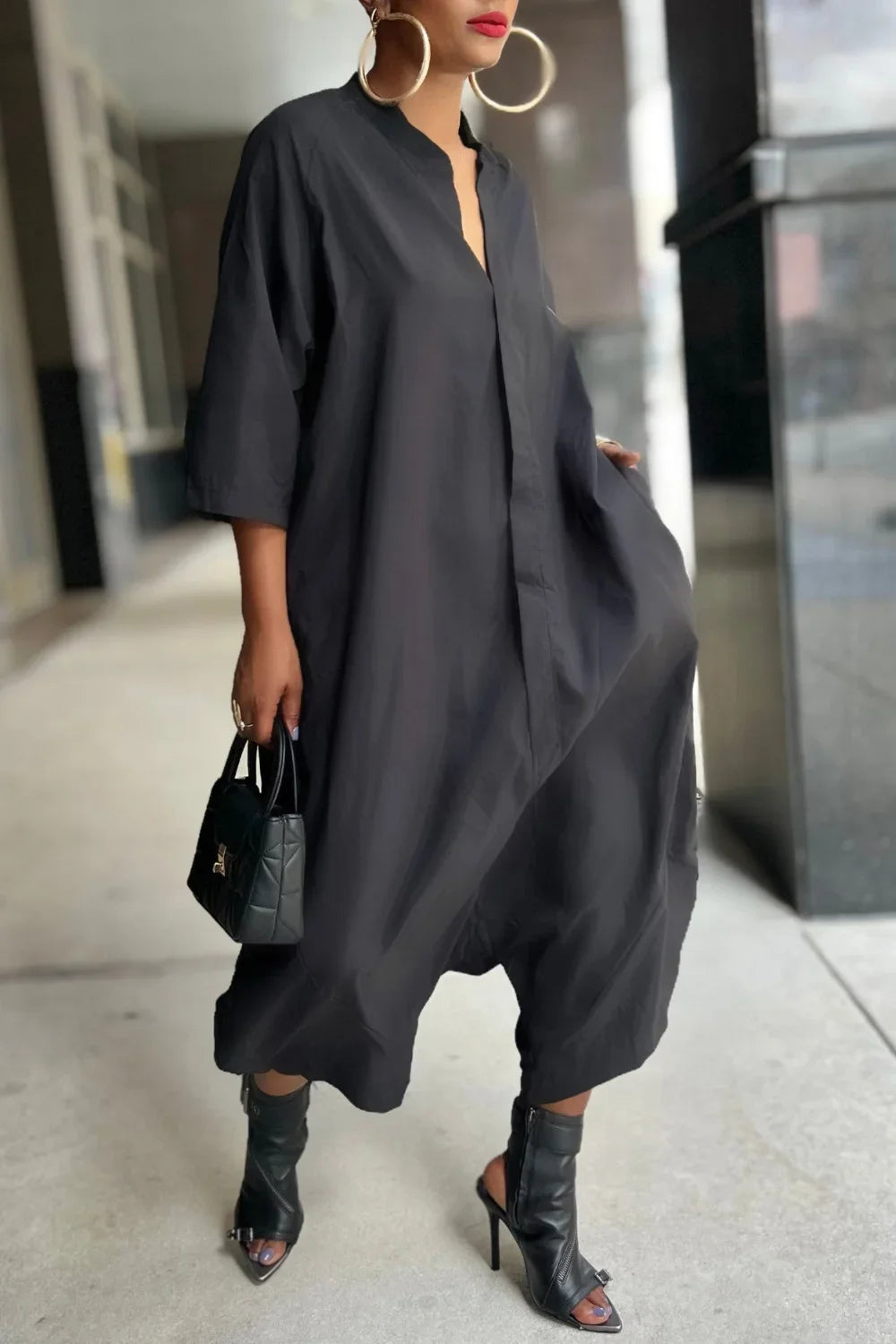 Black loose harem jumpsuit with V-neck, kimono sleeves, and side pockets