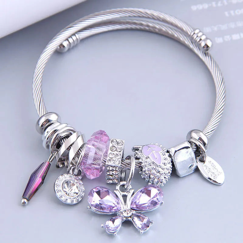 Stainless steel cuff bangle with purple and pink crystal butterfly charms and dangles