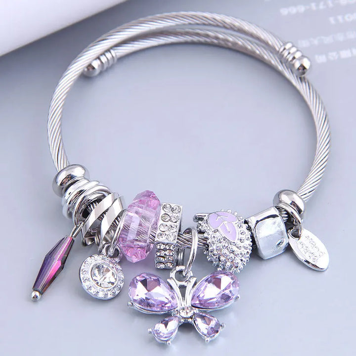 Stainless steel cuff bangle with purple and pink crystal butterfly charms and dangles