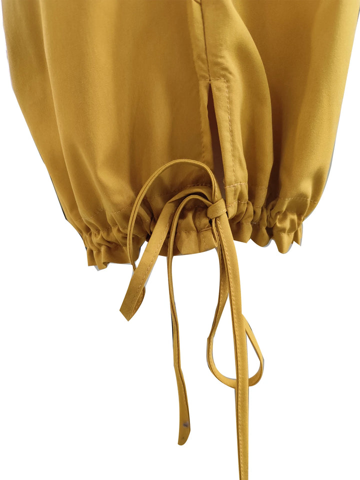 Close-up of the pants' gathered cuff and long adjustable drawstring