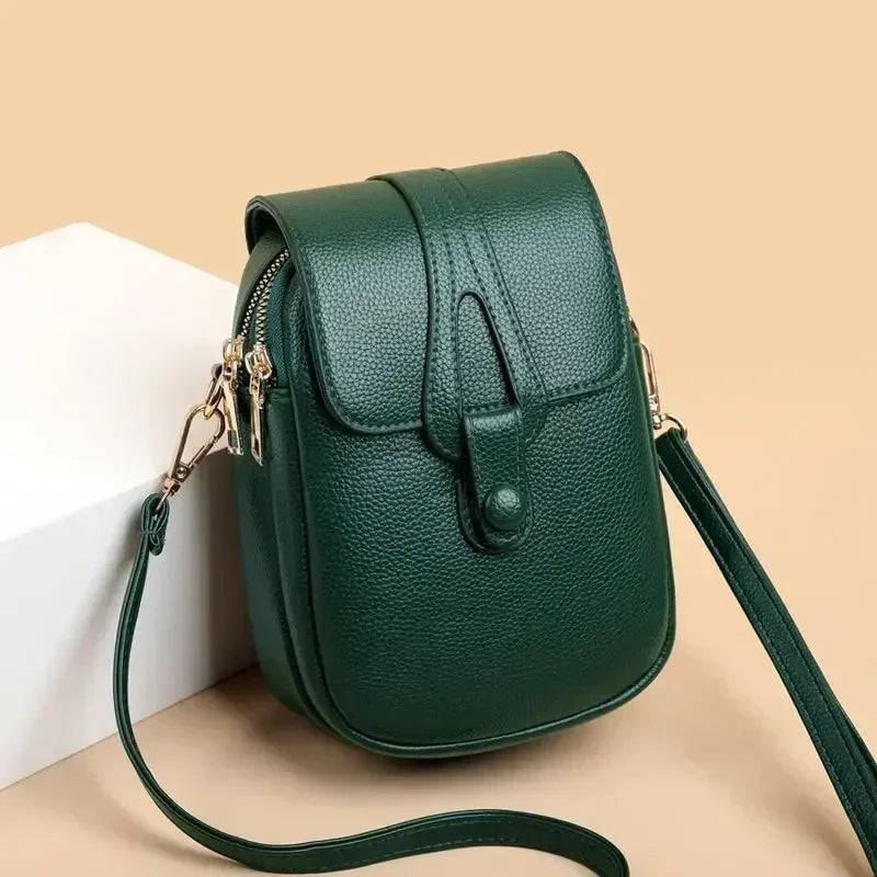 Small crossbody handbag in green with flap front and adjustable shoulder strap