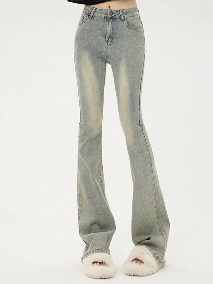 Light blue flared jeans on a white background