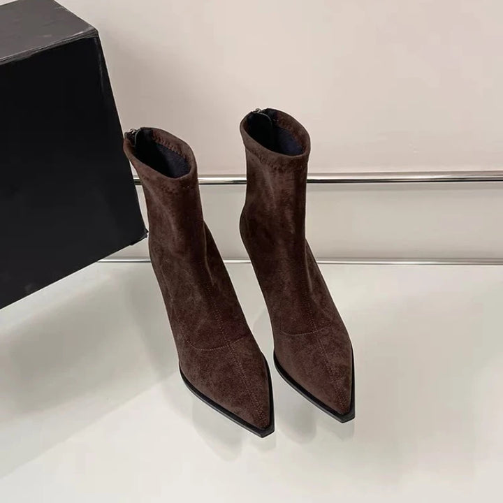 Brown suede pointed-toe ankle boots with slim high heel, two shoes on display