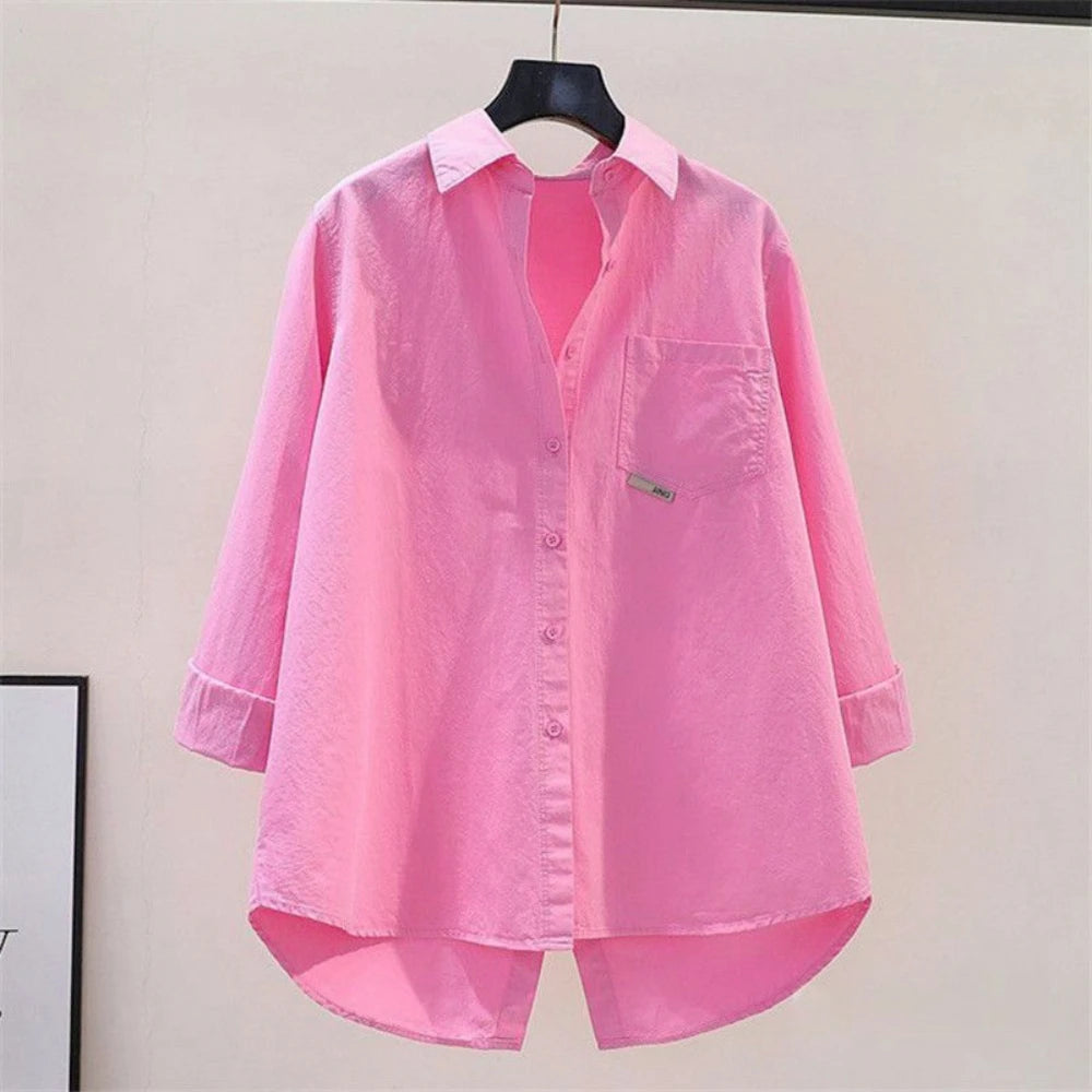 Pink shirt on a hanger against a plain background
