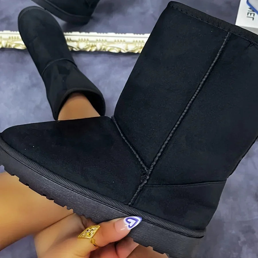 Black corduroy mid-calf platform snow boots, plush-lined collar close-up