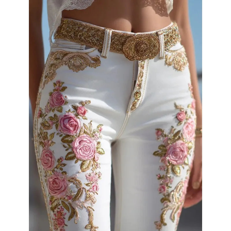 White denim jeans with high waist and straight legs, gold trim and pink rose embroidery