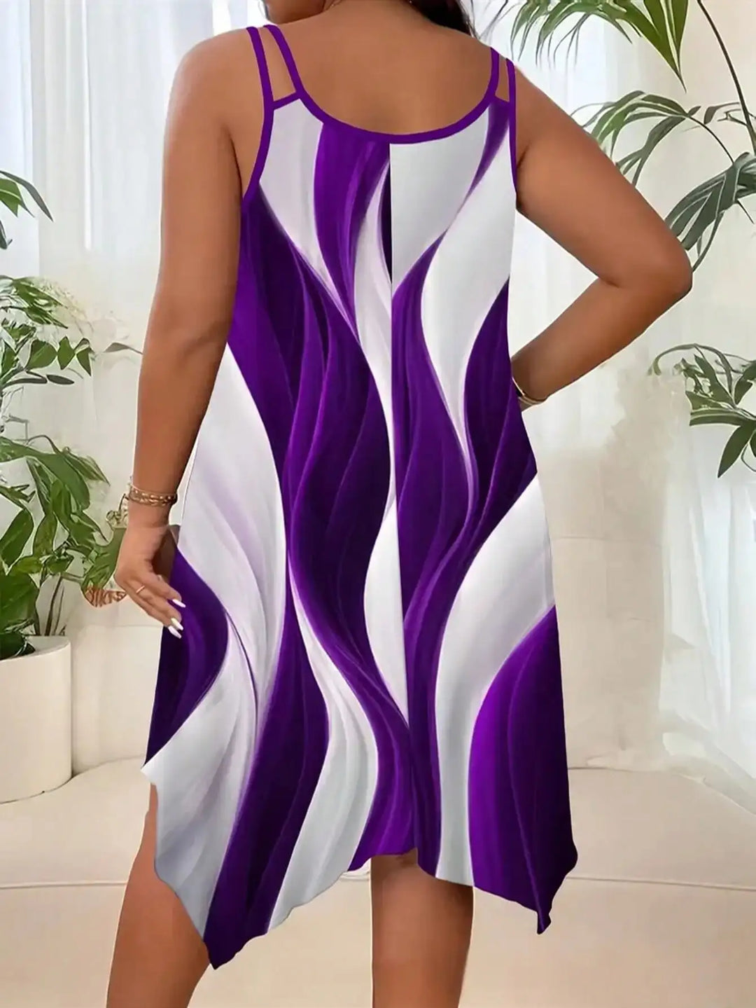 Woman wearing a purple and white dress with a blurred indoor background