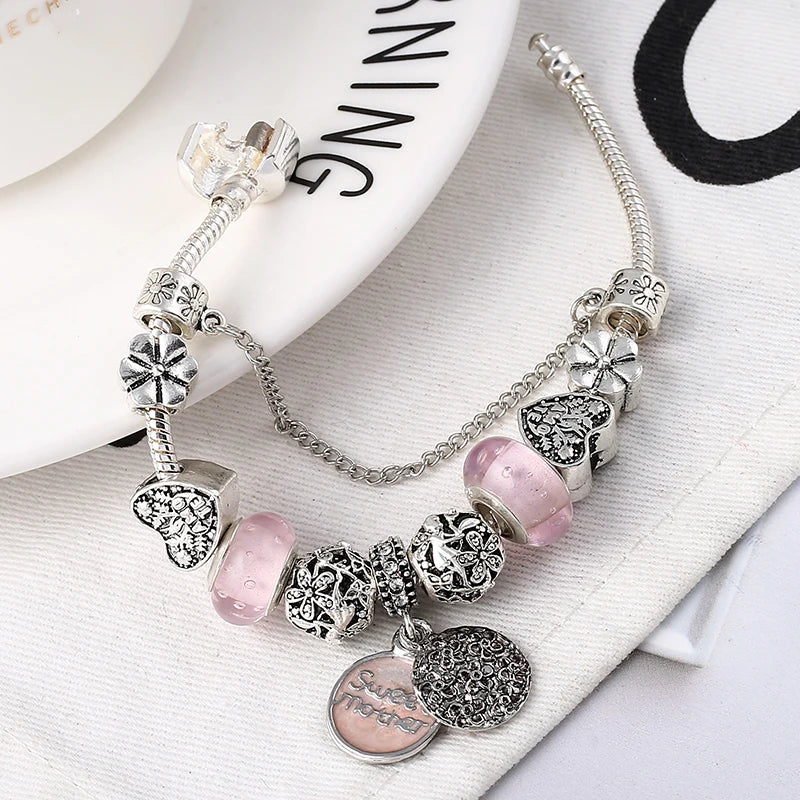 Silver-plated bracelet with heart charms, pink crystal beads, and snake chain links