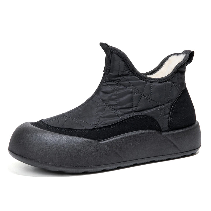 Black slip-on shoe with quilted design on a white background