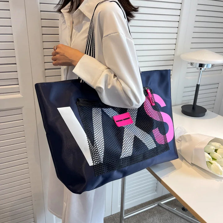DEEP BLUE waterproof nylon tote bag with white letter print and pink logo tag