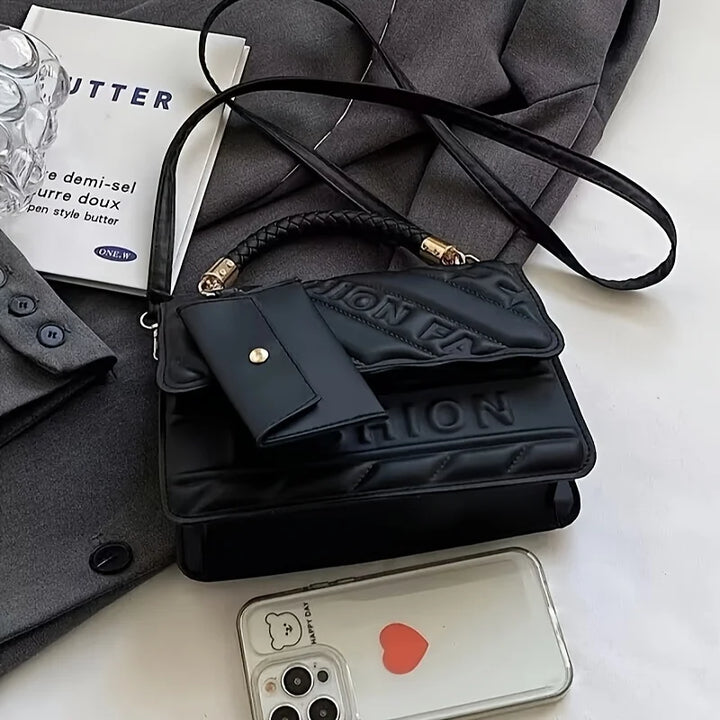 Women’s quilted crossbody bag in black with embossed lettering and mini pouch