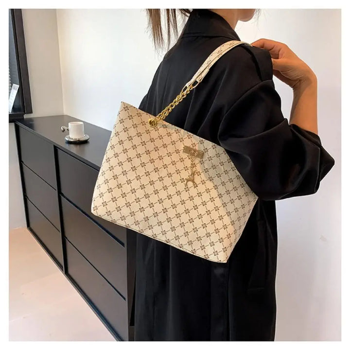 Large patterned bucket tote bag with chain handles and top clasp, light beige