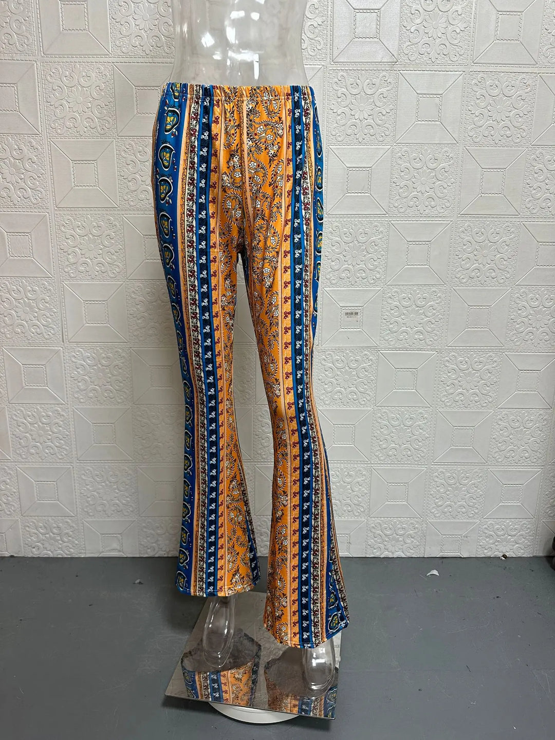 Low-waist flare pants with orange and blue vertical stripes and paisley pattern