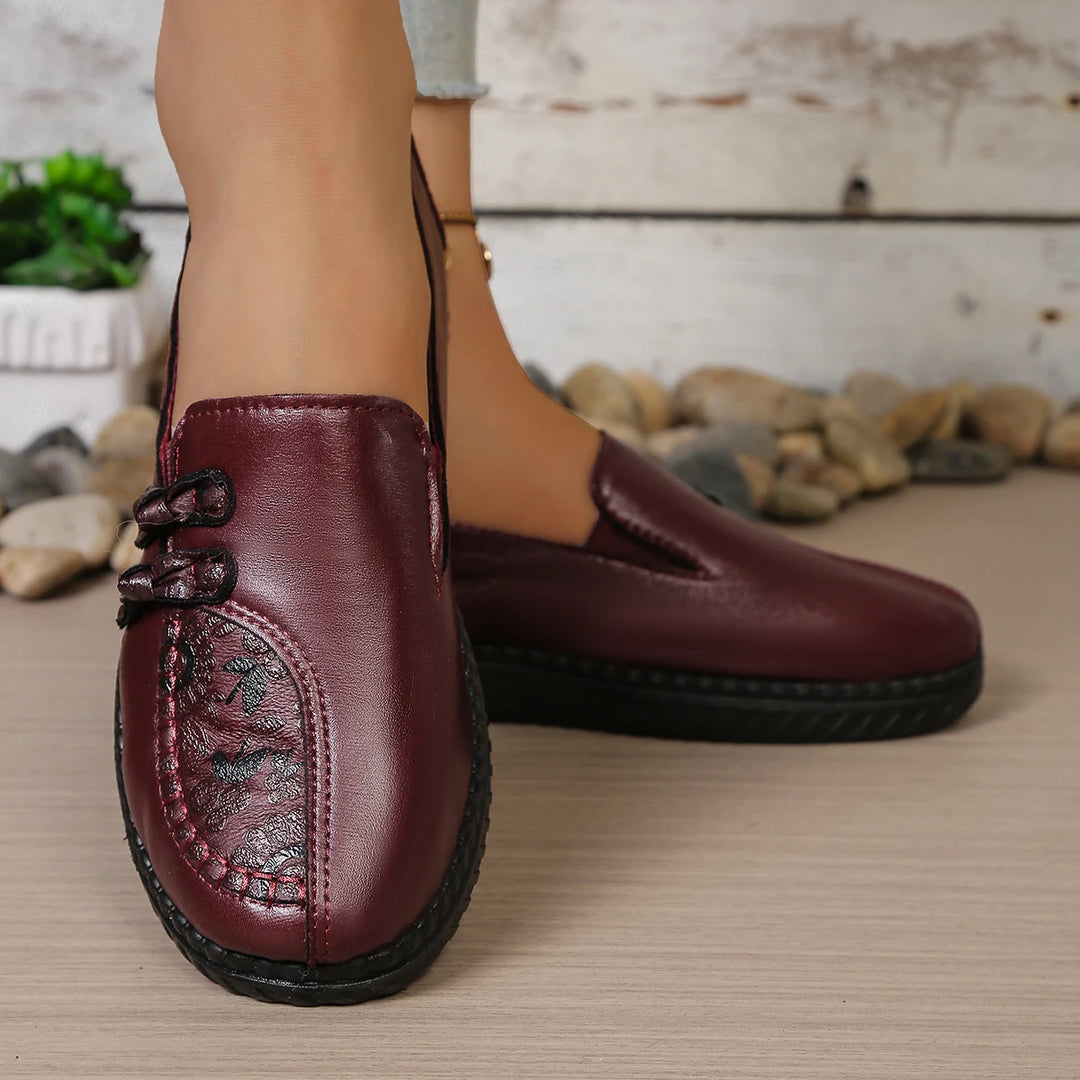 Burgundy leather loafer mule with butterfly-knot bow and round toe stitching detail