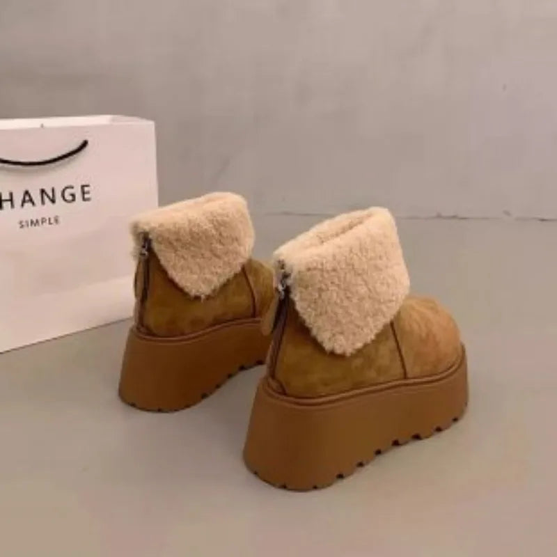 Pair of women's tan suede platform snow boots with cream faux fur cuffs