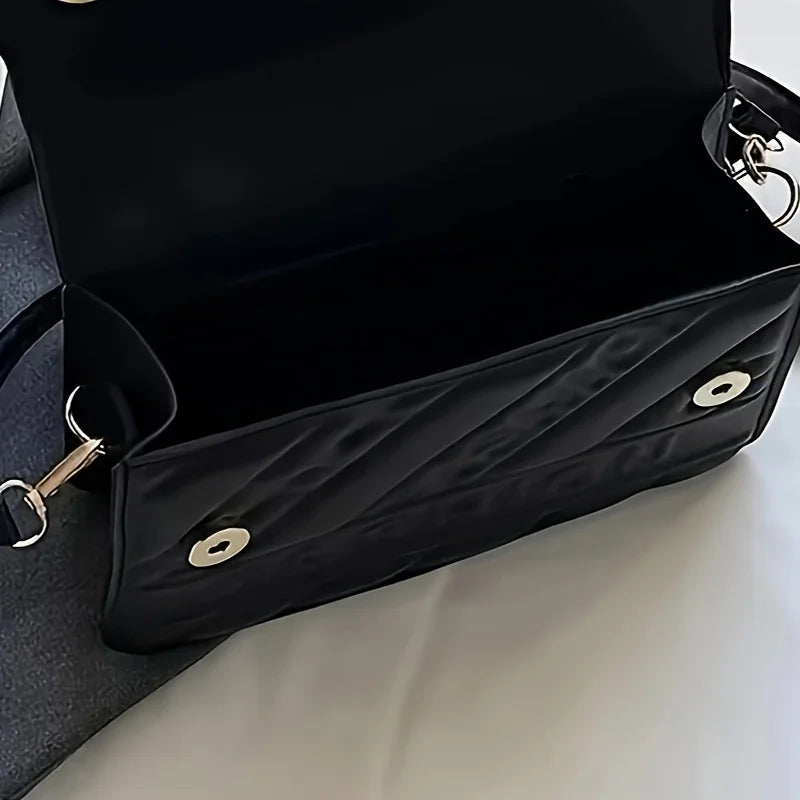 Women’s quilted crossbody bag in black with flap closure and mini coin pouch