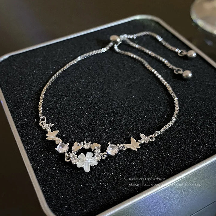 Silver-tone beaded bracelet with star charms and flower-like center stones