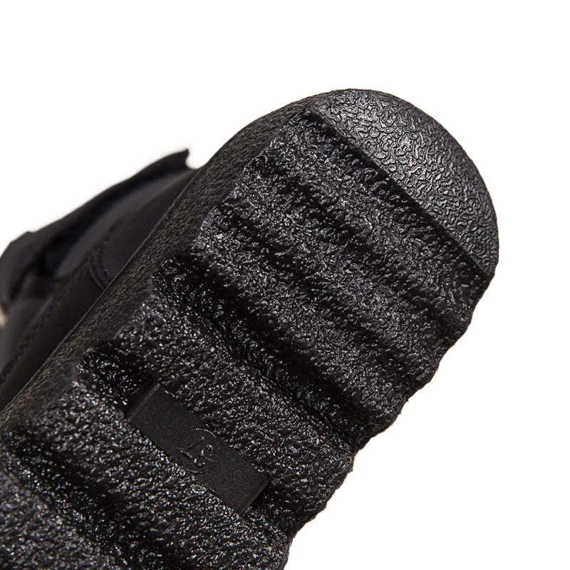 Close-up of a textured black shoe sole on a white background
