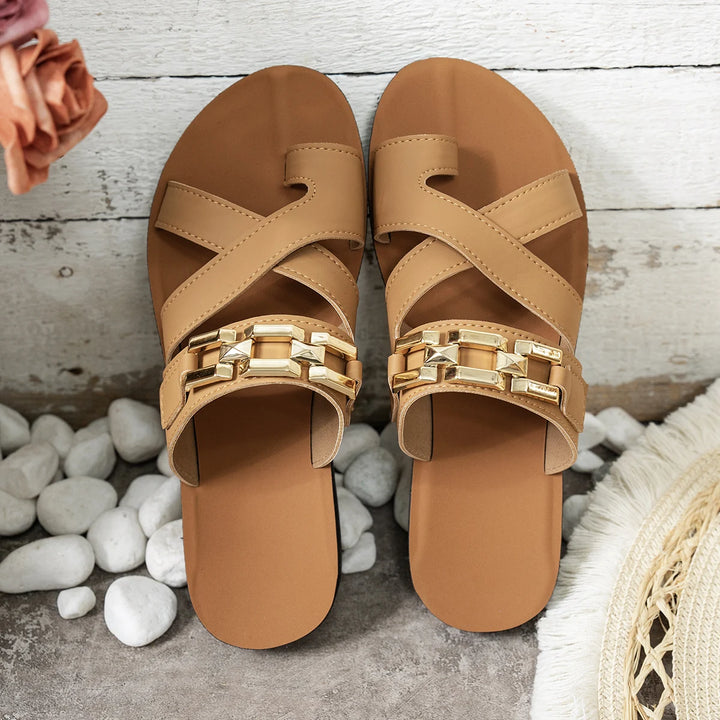 Camel leather slide sandals with gold buckle bar and crisscross straps, flat sole