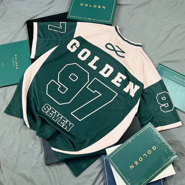 Green and white sports jersey with 'GOLDEN 97' printed on it, surrounded by green books on a gray surface.
