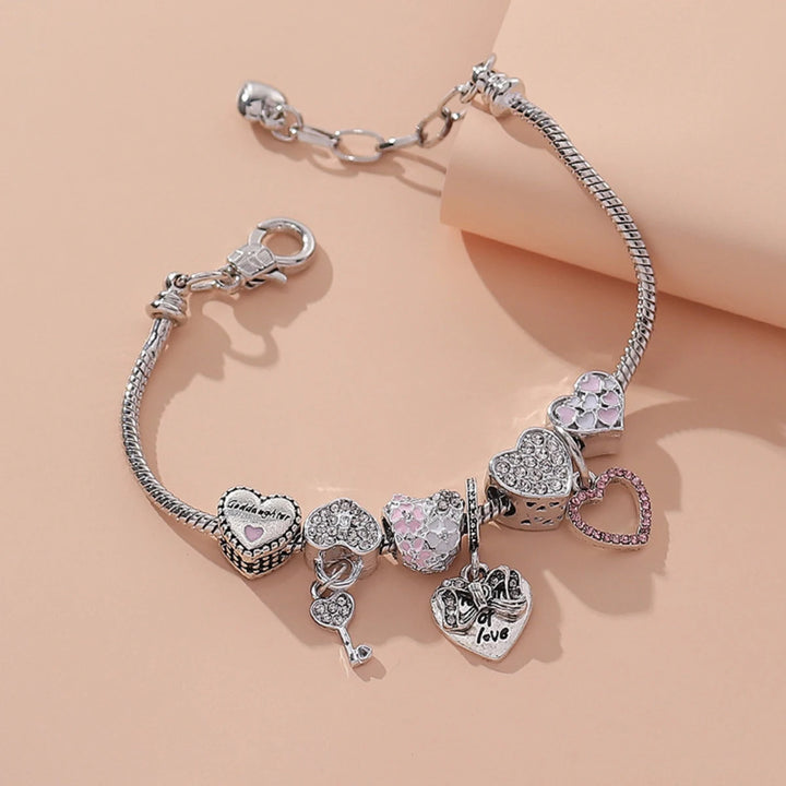 Silver-tone charm bracelet with pink flower hearts and heart padlock-style dangle charms