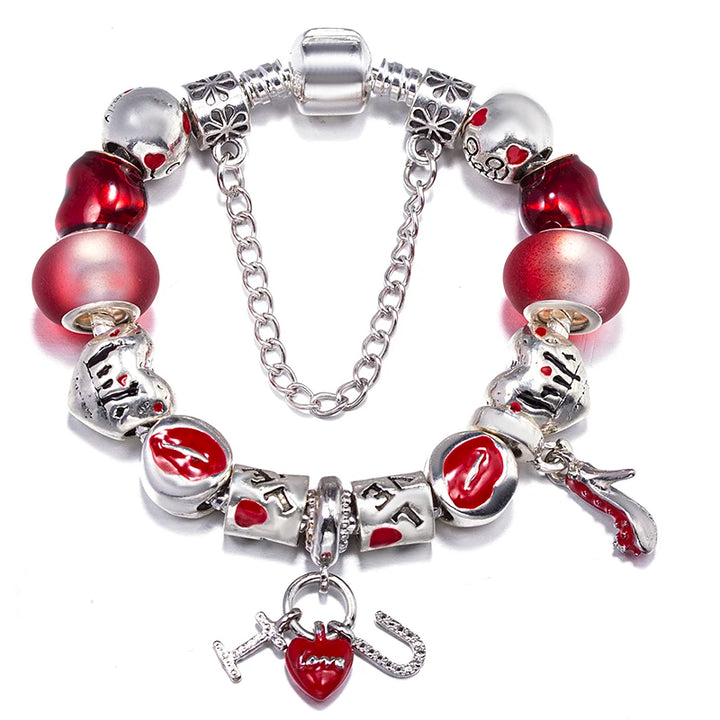 Silver charm bracelet with red heart beads, a cat charm, and a hanging heart pendant
